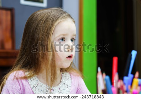 Cute little girl studying to speaking and writing letters at home lesson with her mother