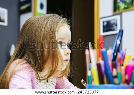 Cute little girl studying to speaking and writing letters at home lesson with her mother