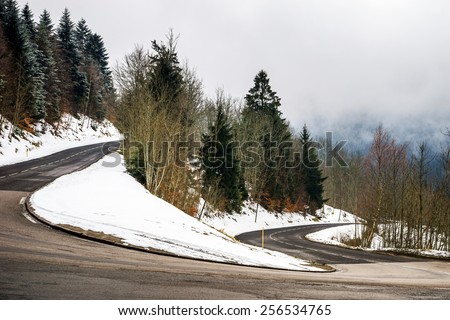 New asphalt auto road in Alsace mountains, France, winter