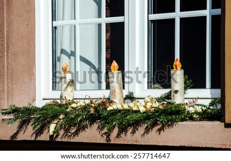 Homemade christmas candles making from birch wood, countryhouse window decoration