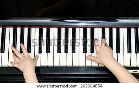 Girl\'s hands and piano keyboard close-up view, education concept