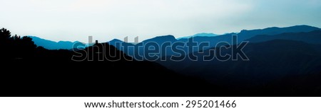 Beautiful panoramic bird-fly view to silhouettes of mountains, travel concept. Italy.