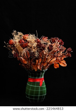 Dried rose bouquet on a black background