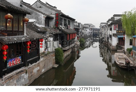 Xitang, China - April 15, 2015: Chinese Traditional Water Village Xitang, which is located in Zhejiang Province in China. Photo Shows Traditional Chinese Houses Along the River on a Cloudy Day.