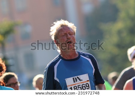 STOCKHOLM - SEPTEMBER 13, 2014: Very tired running man in the Half marathon running event (21 km), Sept 13, 2014 in Stockholm, Sweden