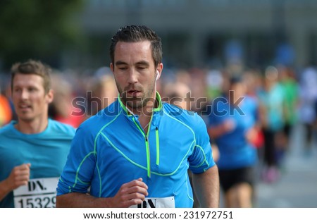 STOCKHOLM - SEPTEMBER 13, 2014: Focused caucasian man running in the Halvmarathon running event (21 km), Sept 13, 2014 in Stockholm, Sweden