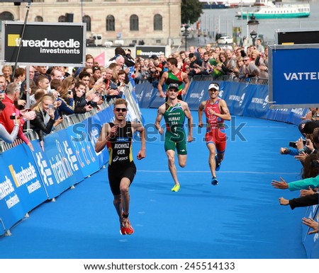STOCKHOLM - AUG 23, 2014: Tough fight between Richard Murray and Mario Mola  and Gregor Buchholz in the Mens\'s ITU World Triathlon series event August 23, 2014 in Stockholm, Sweden