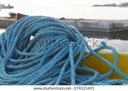 Pile of blue nylon rope in the harbor