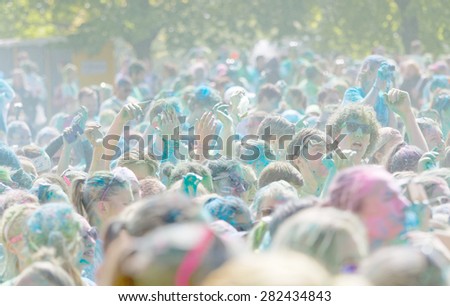 STOCKHOLM - MAY 23, 2015: The happy participator in the Color Run waving their arms in the air in the public event The Color Run, May 23, 2015 in Stockholm, Sweden