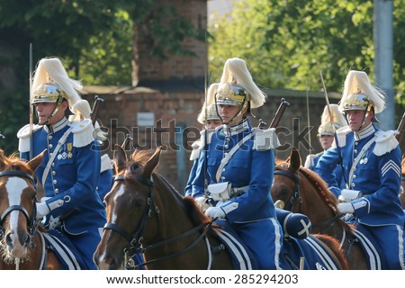 STOCKHOLM - JUN 06, 2015: The Royal guards on the horse back protecting the swedish royal family on their way to celebrate the swedish national day