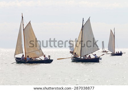 GRISSLEHAMN - JUN 13, 2015: Group of old sailing ships in bright light rowing from Grisslehamn (Sweden) to Eckero (A?land) in the public event Postrodden, June 13, 2015 in Grisslehamn, Sweden
