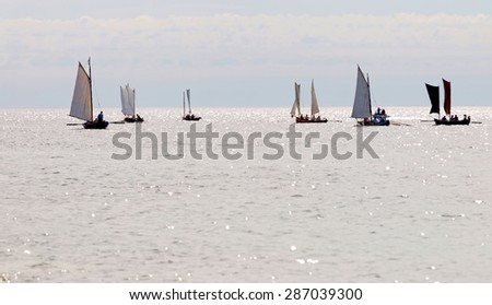 GRISSLEHAMN - JUN 13, 2015: Group of old sailing ships rowing towards the horizon from Grisslehamn (Sweden) to Eckero (A?land) in the public event Postrodden, June 13, 2015 in Grisslehamn, Sweden