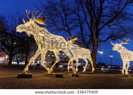 STOCKHOLM, SWEDEN - DEC 20, 2014: Flock of Christmas moose made of led light, December 20, 2014, Nybrokajen, Stockholm, Sweden