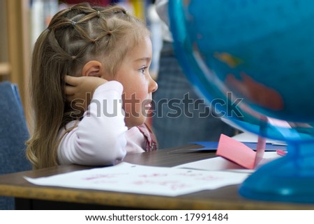 Kindergarten student attentive to geography instruction