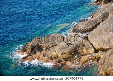 Rocky coast with clean blue see-through water. Cinque Terre, Italy