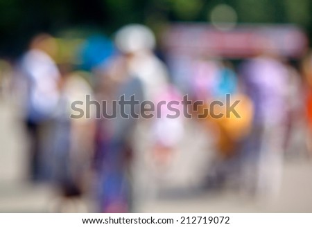 Blurred unfocused city view at day time. Unfocused people in the theme park