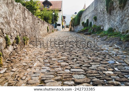 Old cobblestone street in Aigle, Switzerland