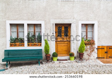 Wooden door, windows and bench