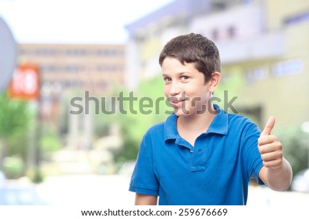boy with all right gesture in front of the school or college