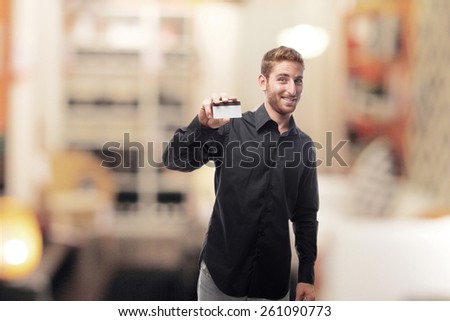 ginger young man with shirt with credit card