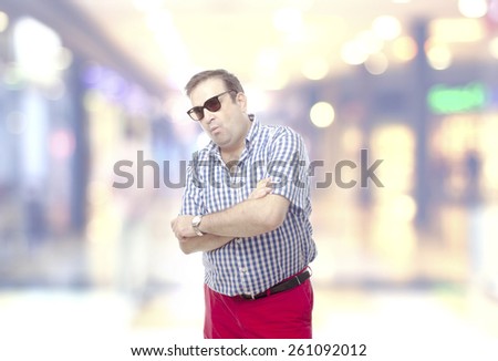 nerd man boasting with sunglasses in the shopping center