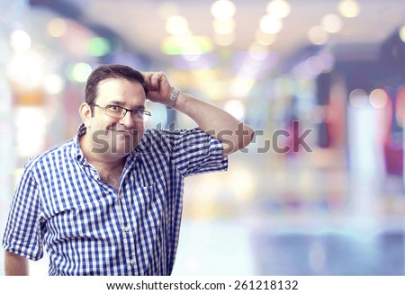 nerd man scratching head like a monkey in the shopping center