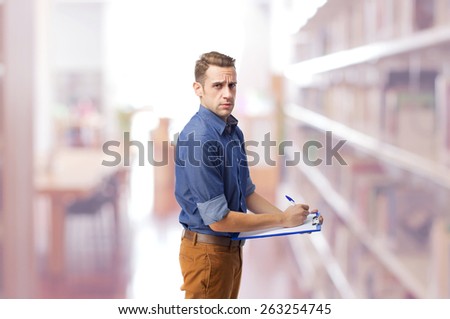cool man writing in folder with clip in a library