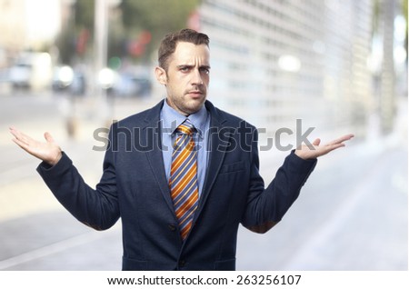 surprised and confused man in suit in front of an office