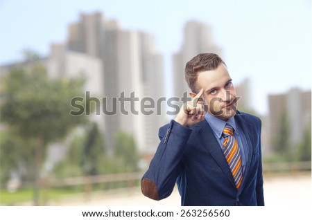 Man in suit self-confidence in front of skyscrapers