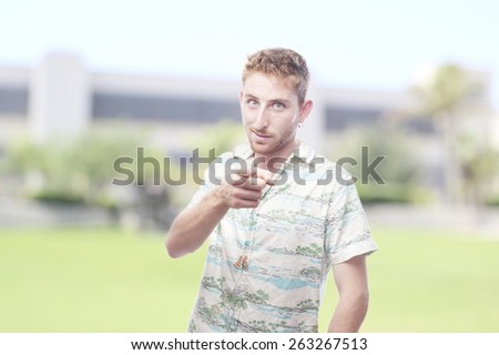 ginger young man with hawaiian shirt pointed at you