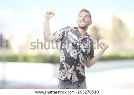 ginger young man with hawaiian shirt celebrating something