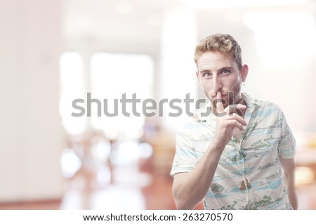 ginger young man with hawaiian shirt silence gesture