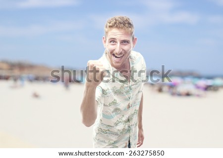 winner ginger young man with hawaiian shirt in the beach