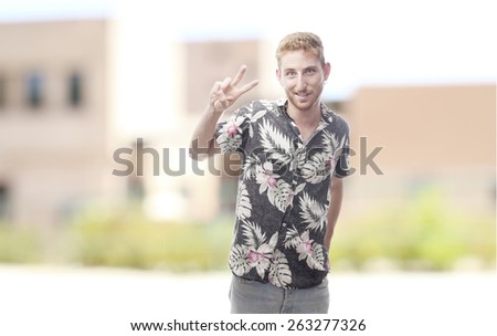 ginger young man with hawaiian shirt victory gesture