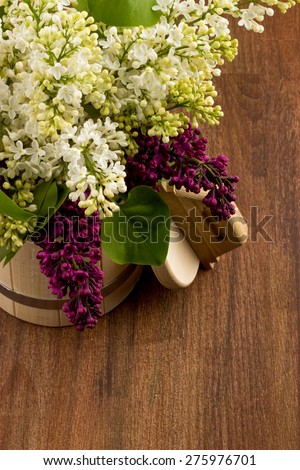 white lilac, lilac purple, white sheet of paper with hearts punching, punching with flowers on turquoise background, on a brown background, wooden tubs