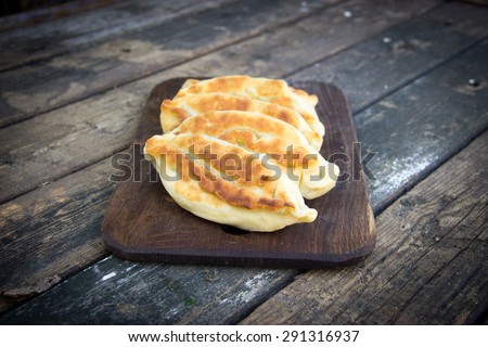 Fried pies on a wooden chopping board