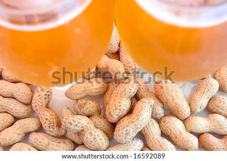 Beer in glass  and  snack - peanuts  in shells.