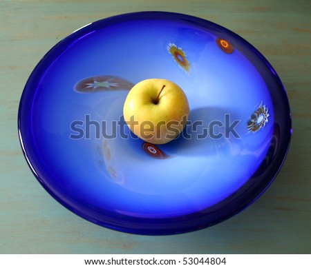 yellow apple in blue deco bowl