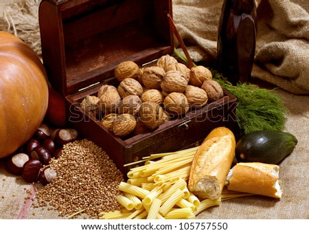 Still life with chest, nuts, pumpkin, bread and pasta
