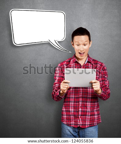 Asian man with speech bubble and touch pad in his hands got good news