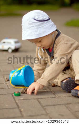 Baby Boy Playing on the Ground in The Park. Summer or spring activity for child