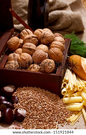still life with chest, nuts, pumpkin, bread and pasta