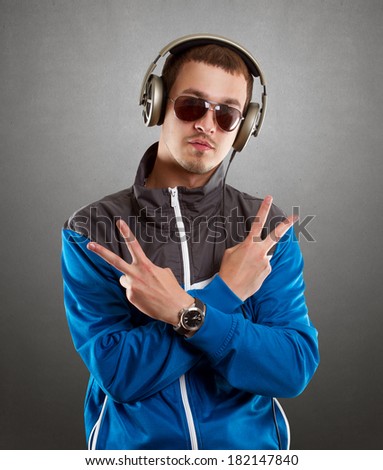 DJ Man in glasses with headphones looking at camera