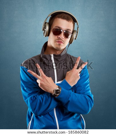 DJ Man in glasses with headphones looking at camera