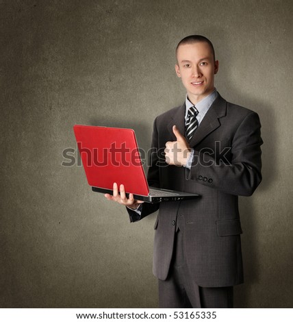 businessman in expensive suit with red laptop