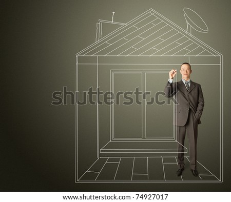 asian male businessman with marker in fictional house writing something on glass write board