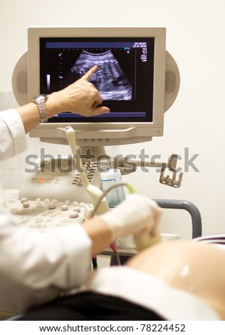 medical examining pregnant belly by ultrasonic scan