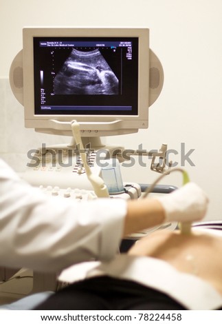 medical examining pregnant belly by ultrasonic scan