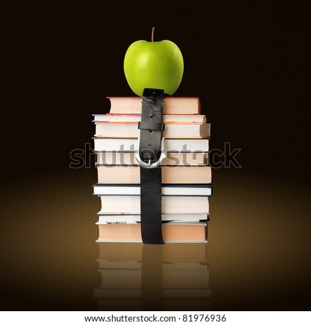 many books pile with black leather belt