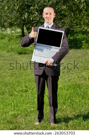 Man working outdoors as a freelancer, feels happy and shows well done
